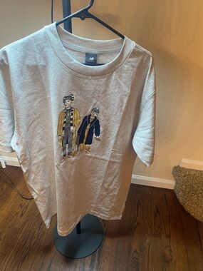 New Balance Beige Graphic Short Sleeve Tee with Illustrated Characters